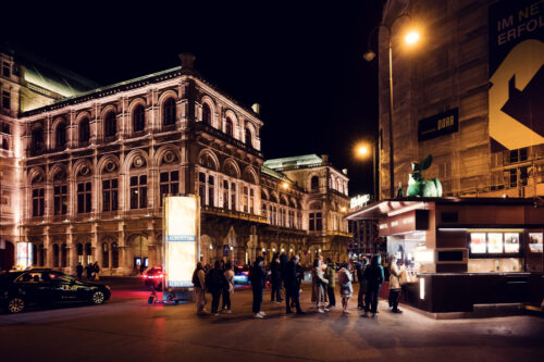 Crowd waiting in line at Bitzinger Würstelstand, a popular spot for Vienna's famous sausages.