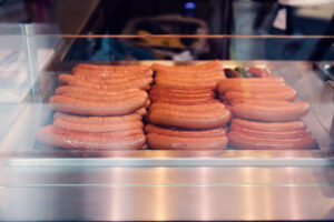 Delicious assortment of sausages sizzling at Bitzinger Würstelstand, a staple of Viennese street food.