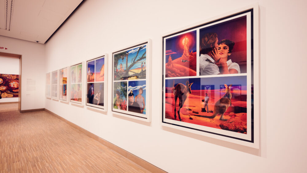 A brightly lit gallery at Albertina Modern museum, featuring a series of colorful, surrealist paintings along the wall.