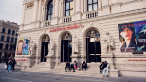 Visitors on the steps of Albertina Modern, exhibition banners flanking the entrance columns.