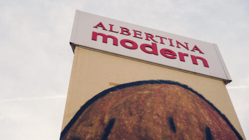 Albertina Modern sign with bold red lettering above a large-scale artwork on the facade.