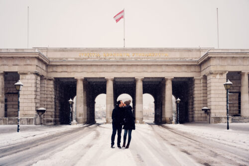 Winter romance at Heldenplatz's main gate, surrounded by snow.