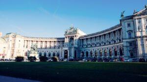 Summer view of the Neue Burg with its sweeping curved facade at Heldenplatz.