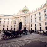 Elegant fiaker parked outside Hofburg Palace, showcasing Vienna's historic charm.