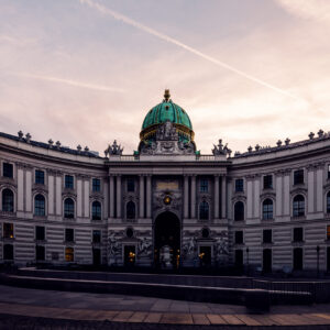 Panoramic view of Hofburg Palace from Kohlmarkt, capturing its regal presence in Vienna.