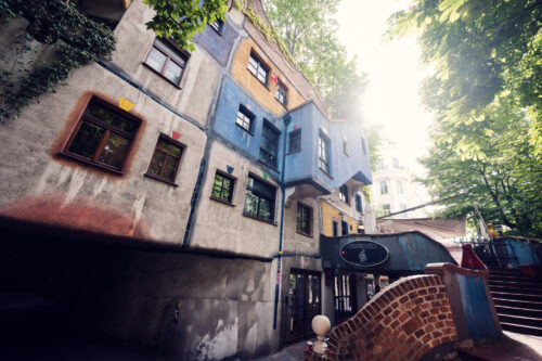 Street-level perspective of Hundertwasserhaus showing the relationship between art and daily life in Vienna.