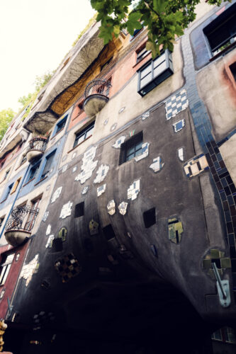 Living walls of Hundertwasserhaus where vegetation integrates with architecture, demonstrating perfect harmony between nature and design.