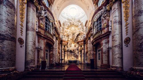 The grand interior of St. Charles Church (Karlskirche) in Vienna, highlighting its ornate baroque design.