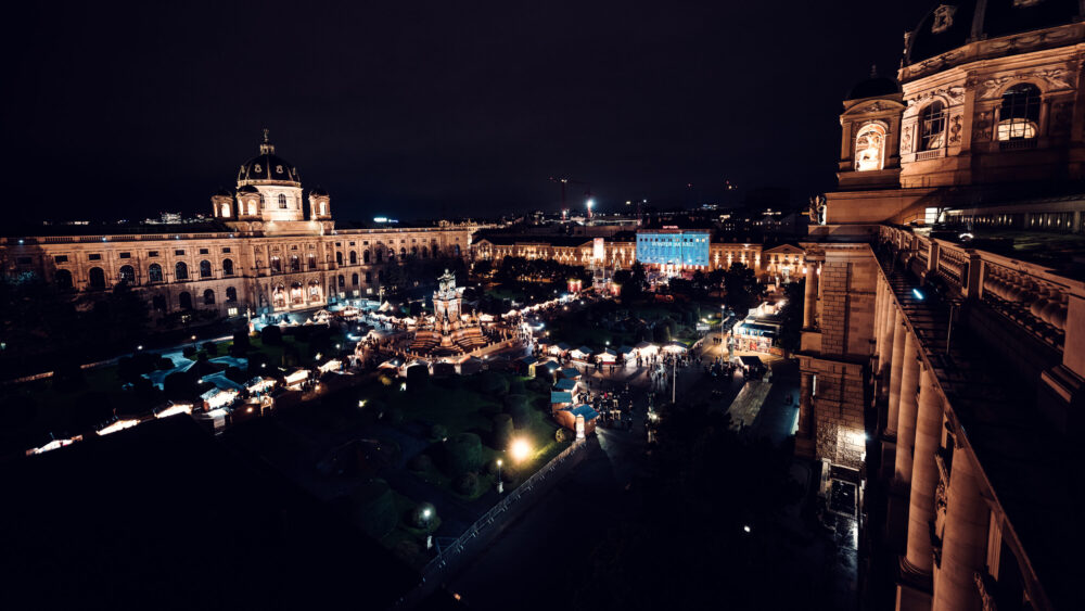 The Kunsthistorisches Museum Vienna by night, with the Christmas market in front on Maria-Theresien-Platz.