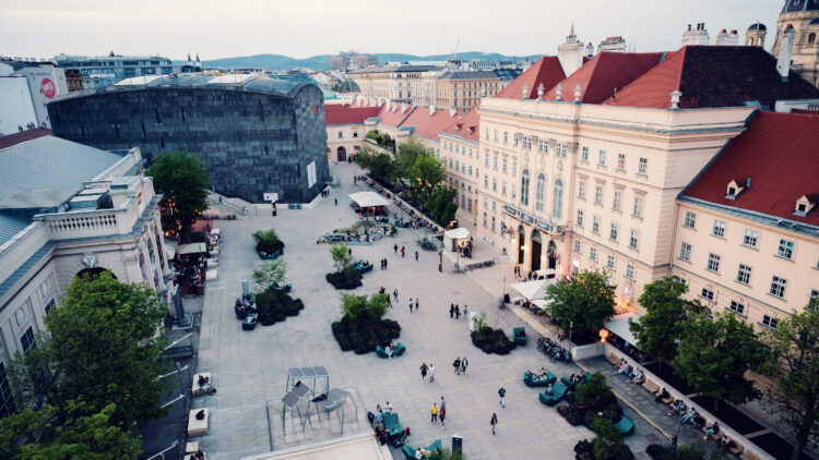 View from MQ Libelle terrace overlooking Museumsquartier Vienna with historic baroque buildings and modern museum architecture.