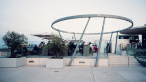 Modern architecture of MQ Libelle Vienna featuring curved glass facade and contemporary design at Museumsquartier rooftop.