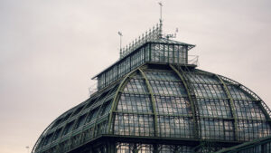 Ornate iron details of the Palm House Schönbrunn in morning mist.