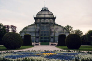 Entrance of the Palm House Schönbrunn with ornate ironwork details.
