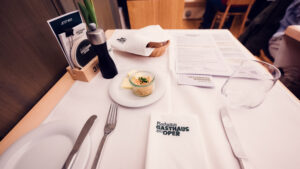 Traditional table setting at Plachutta zur Oper, where crisp white linens and polished silverware demonstrate Viennese dining excellence.