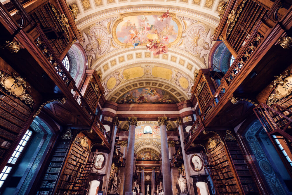 Close-up of the Prunksaal's ceiling medallions, showcasing Baroque artistic mastery.