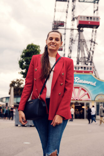 Adriana in front of the majestic Giant Ferris Wheel (Wiener Riesenrad).