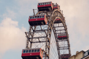 Intimate view of a vintage Giant Ferris Wheel (Wiener Riesenrad) cabins against the Vienna sky.