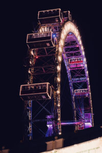 Dramatic night photography of the Giant Ferris Wheel (Wiener Riesenrad), showcasing its majestic silhouette.