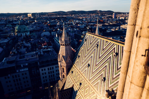 Zigzag pattern of St. Stephen's Cathedral roof tiles in green, yellow, and white.