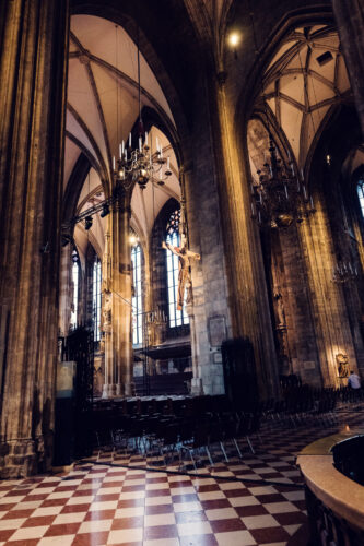 Sunlight streaming through historic stained glass windows of the St. Stephen's Cathedral.