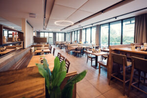Main dining room of Stöckl im Park Vienna with original woodwork and contemporary interior design.