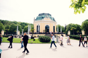 People visiting Schönbrunn Zoo Vienna walking through pathways with families and children exploring animal exhibits.
