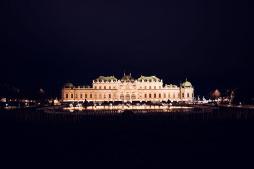 Evening illumination highlighting Belvedere Castle's architectural features.