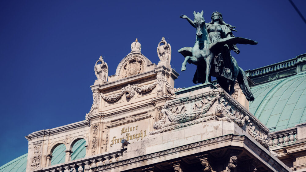 Ornate rooftop details of the Vienna State Opera.