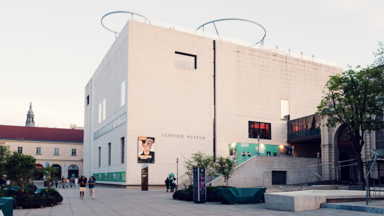 Exterior of Leopold Museum Vienna with its distinctive white limestone cube design in the MuseumsQuartier cultural complex, showcasing modern architectural minimalism.