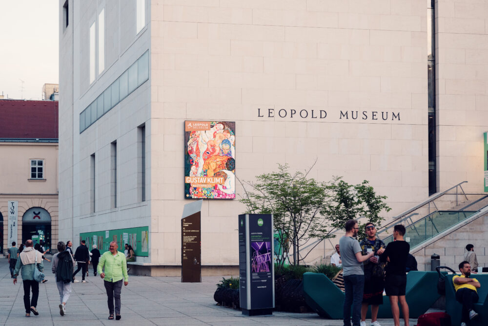 Leopold Museum's geometric white facade contrasting with the historic Habsburg imperial architecture of Vienna's MuseumsQuartier.