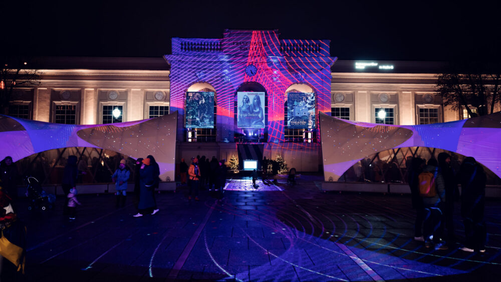 Festive winter illumination at MuseumsQuartier Vienna transforming cultural complex into magical evening scene.
