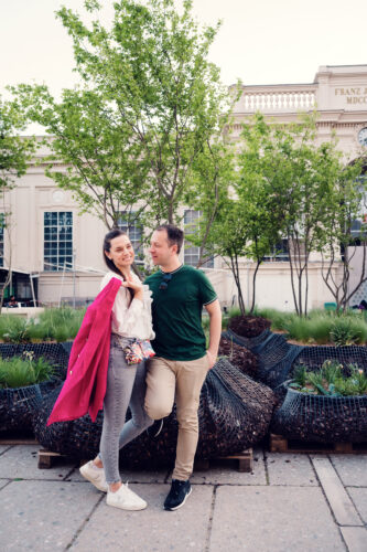Romantic moment at MuseumsQuartier's main courtyard featuring couple posing against baroque facade backdrop.
