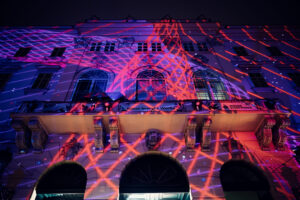 Artistic lighting design illuminating MuseumsQuartier's architectural features.