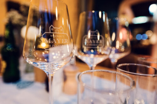 Row of wine bottles lined up for tasting at Heuriger Mayer am Pfarrplatz.