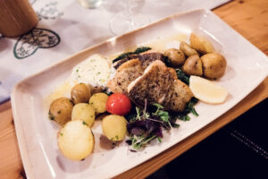 Fish dish served on a white plate at Heuriger Mayer am Pfarrplatz.