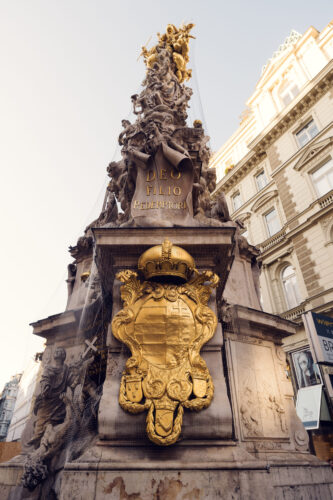 The coats of arms on the Pestsäule represent the Habsburg Monarchy and emphasize the emperor’s role as a ruler chosen by God.