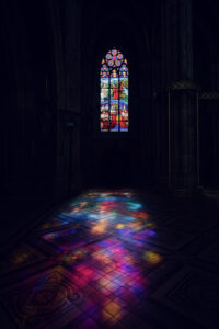 Magnificent stained glass windows of Votivkirche Vienna (Votive Church) with vibrant colors.