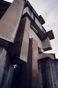 Angled view of Wotrubakirche with sharp concrete lines against the sky.
