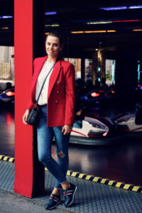 Adriana posing at Autodrom bumper car attraction Prater Vienna Austria, classic carnival ride experience in historic Wiener Prater amusement park.