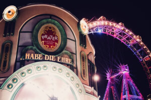 Night scene at Prater Vienna Austria, traditional amusement park with festive lighting and illuminated attractions creating vibrant nighttime atmosphere in historic Prater.
