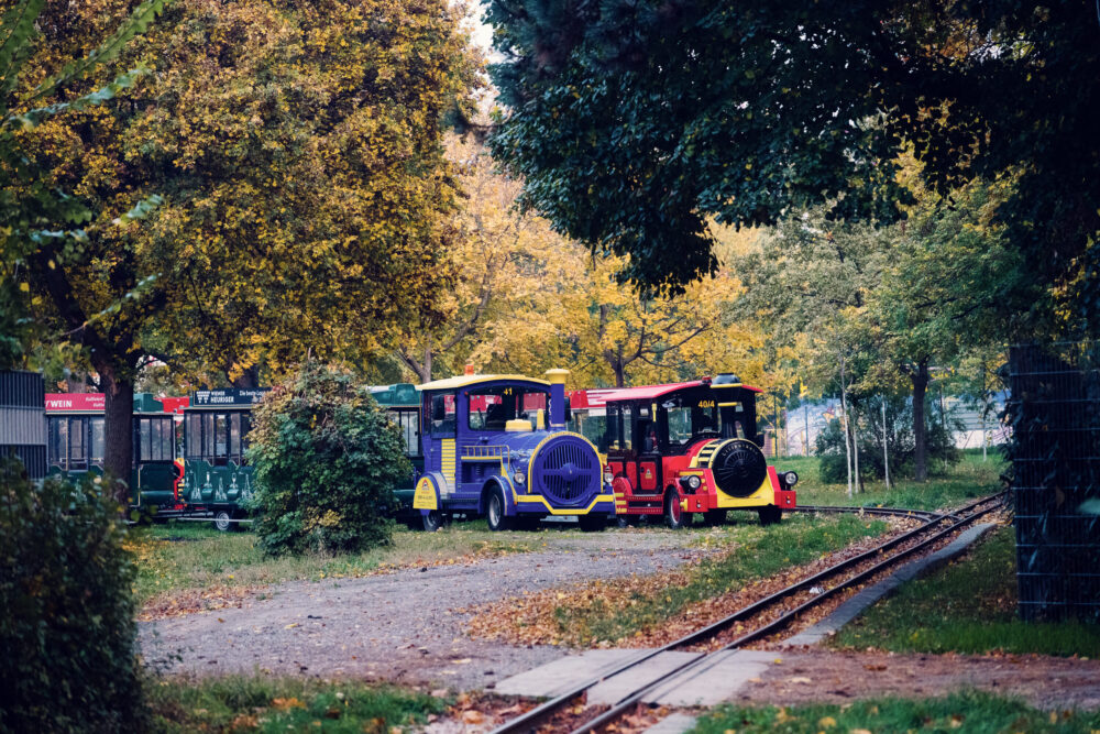 Liliputbahn miniature railway at Prater Vienna Austria, small-scale train ride attraction with colorful carriages in historic Wiener Prater amusement park.