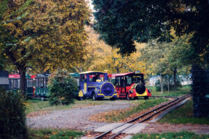 Liliputbahn miniature railway at Prater Vienna Austria, small-scale train ride attraction with colorful carriages in historic Wiener Prater amusement park.