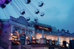 Madame Tussauds Vienna at night in Prater Austria, illuminated wax museum building with evening lighting and signage in historic Wiener Prater entertainment district.