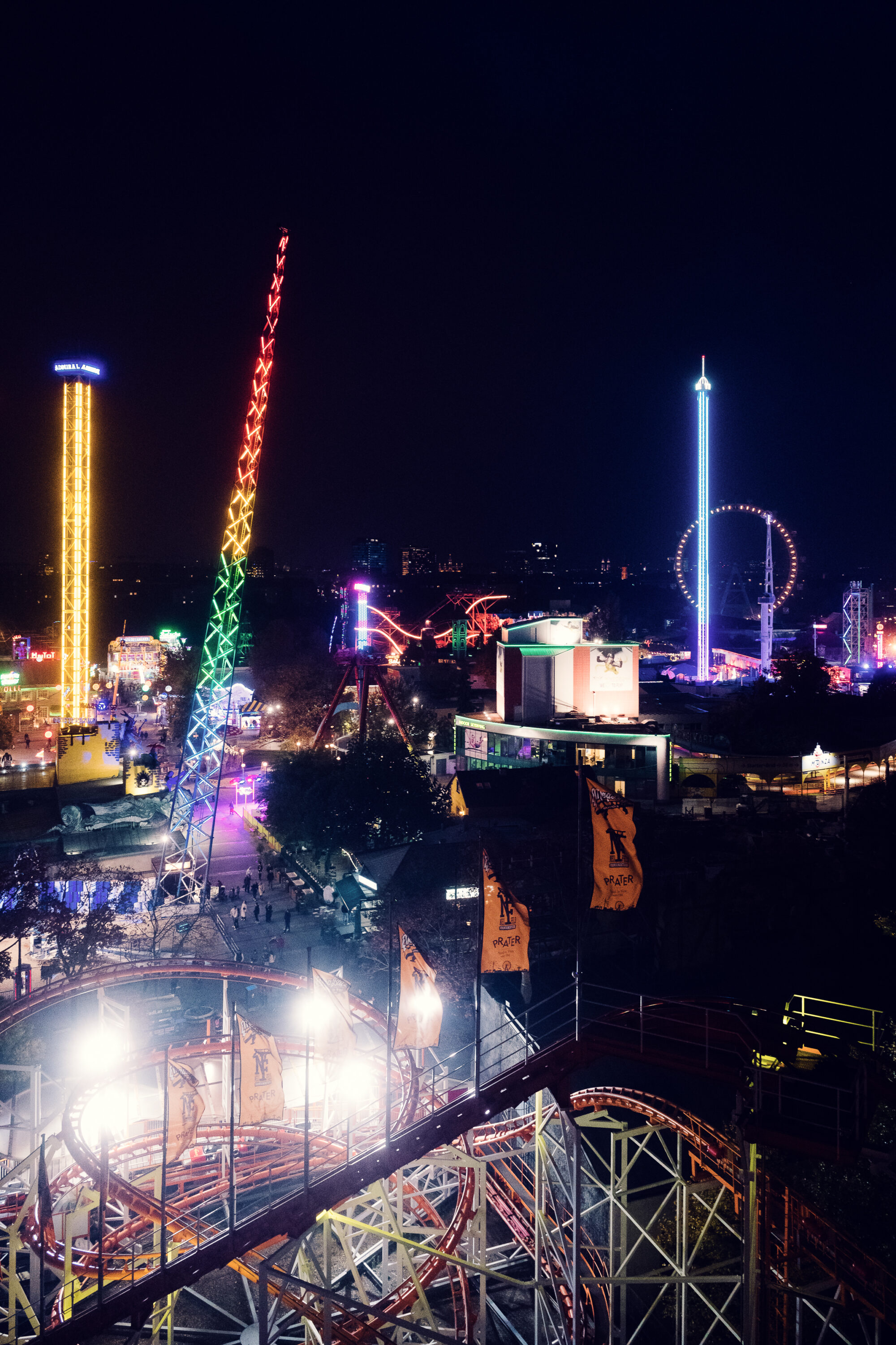Night view of Prater amusement park Vienna Austria, illuminated carnival rides and attractions with colorful lighting in historic Wiener Prater entertainment district.