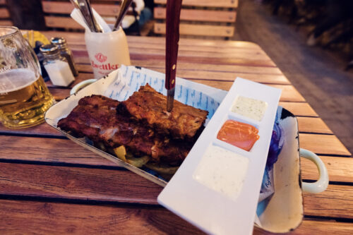Grilled spare ribs with dipping sauces and a draft beer at Brandauer's Schlossbräu.