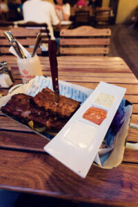 Close-up of spare ribs served with three dipping sauces at Brandauer's Schlossbräu.