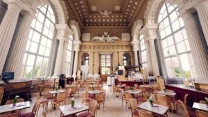 Spacious main hall of Café Gloriette with white columns and large windows overlooking Schönbrunn.
