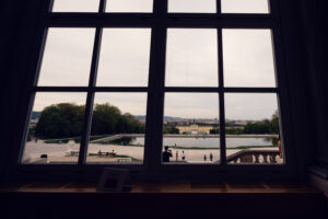 View through the window of Café Gloriette toward Schönbrunn Palace and the gardens below.