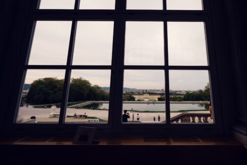 View through the window of Café Gloriette toward Schönbrunn Palace and the gardens below.