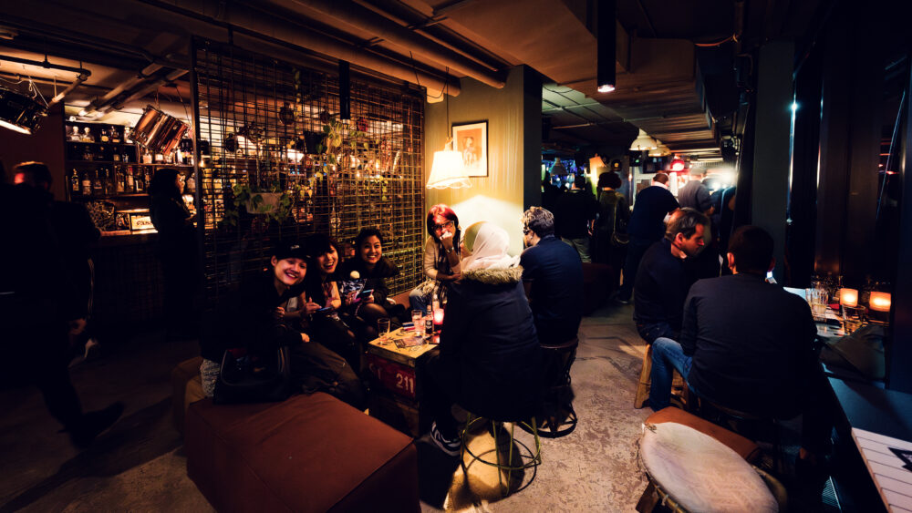 Relaxed and trendy atmosphere at Der Dachboden rooftop bar, offering stunning views and a vibrant social scene in Vienna.